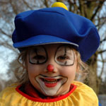 young girl wearing a clown costume
