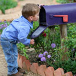 boy looking inside mailbox